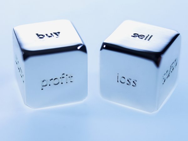Dice spelling out Buy, Sell, Loss, Profits, and more.